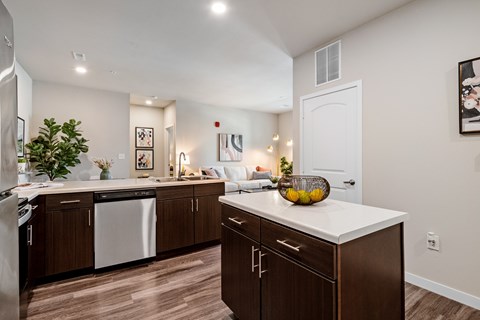 A modern kitchen with dark wood cabinets and white countertops.