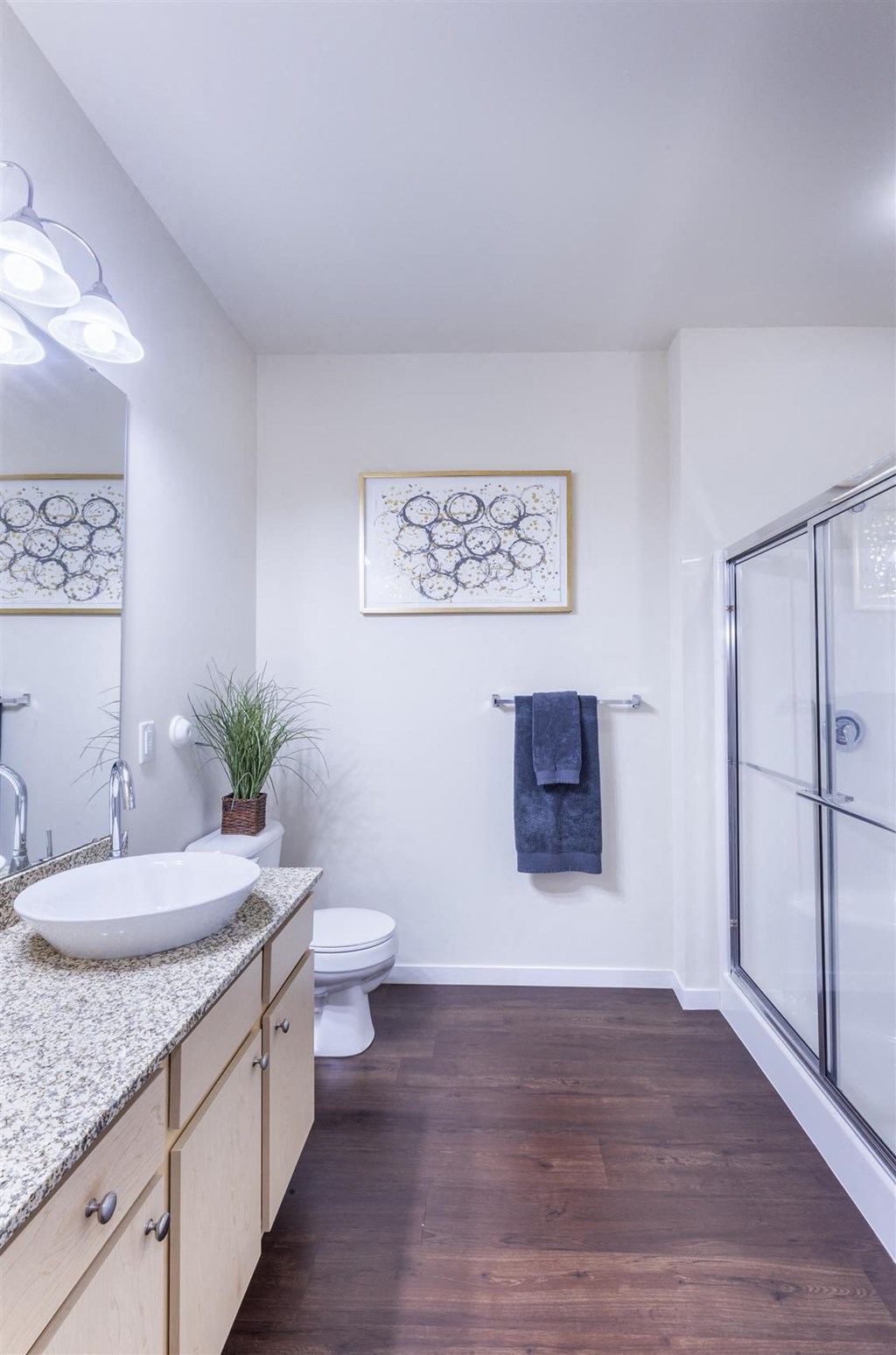 a bathroom with a sink and a shower and a toilet