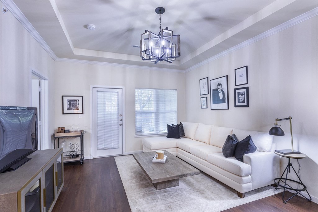 a living room with a white couch and a tv