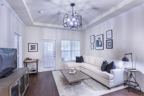 A living room with a white couch and a coffee table.