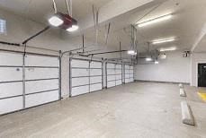 the inside of a garage with white walls and doors