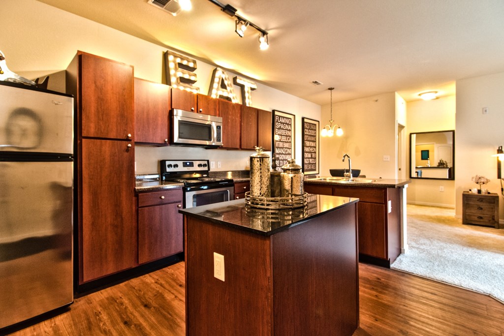 a kitchen with stainless steel appliances and an eat in counter top  at Aventura at Mid Rivers, St. Charles, 63304