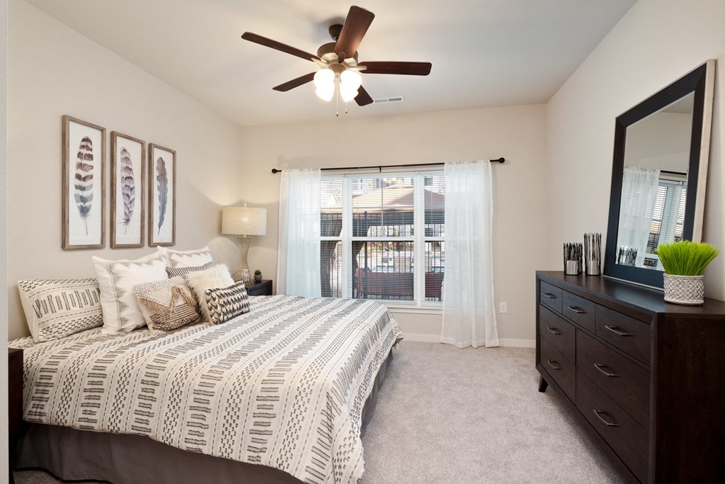 a bedroom with a large bed and a ceiling fan