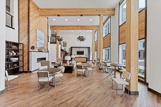a large room with wood floors and a fireplace