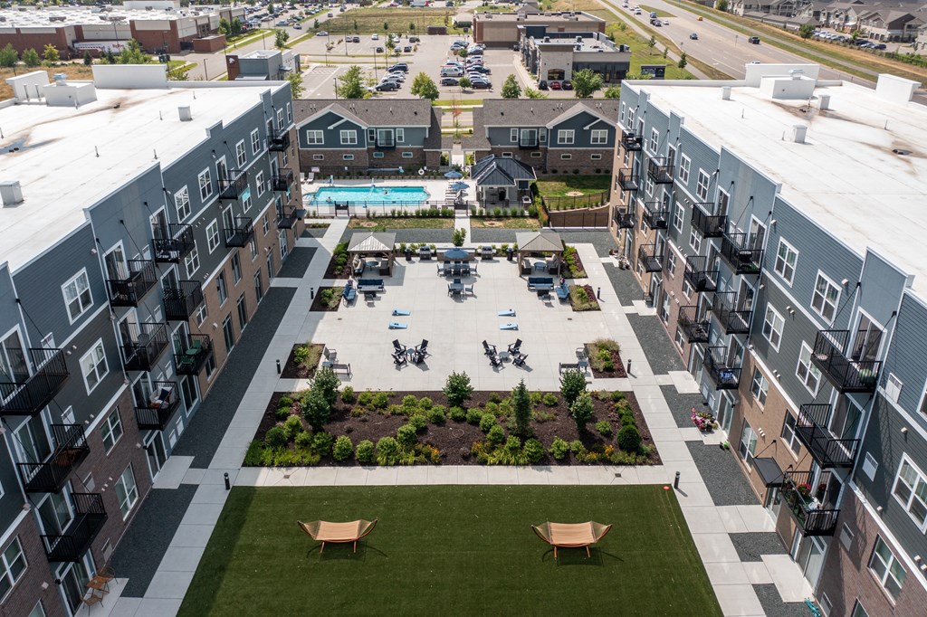 an aerial view of an apartment complex with a pool in the middle  at The Edison at Spirit, Lakeville, MN
