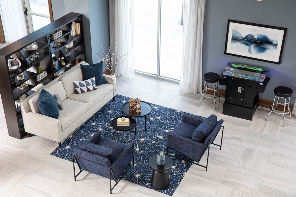 a living room filled with furniture and a large window  at The Edison at Spirit, Minnesota, 55044
