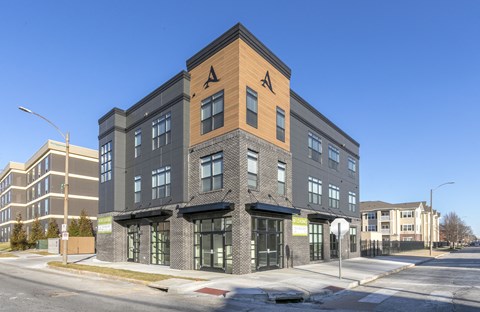 a brick and wood building on the corner of a city street