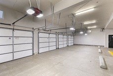 a large empty garage with white walls and doors