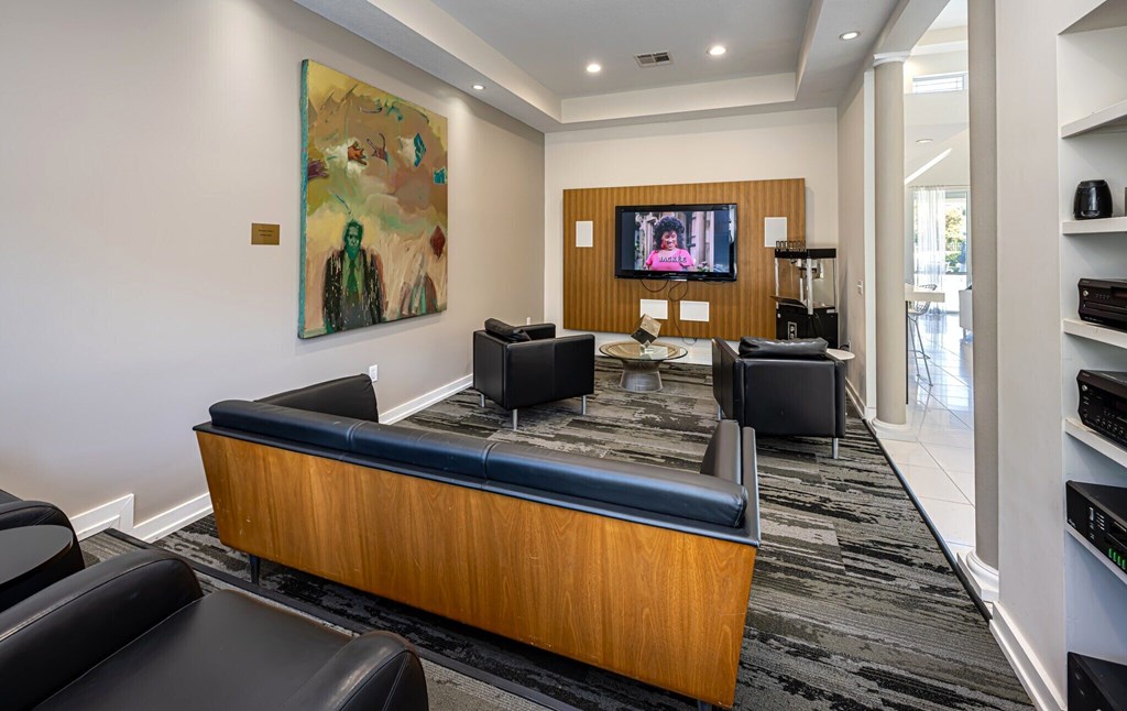 A modern living room with a couch, chair, and television.