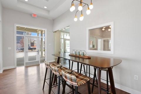 A dining room with a wooden table and chairs.