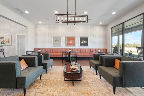 A living room with grey couches and a brown rug.