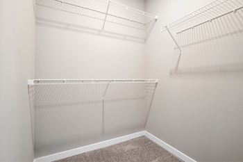 Empty white shelves in a room at Aventura at Wentzville I & II Apartments, Missouri