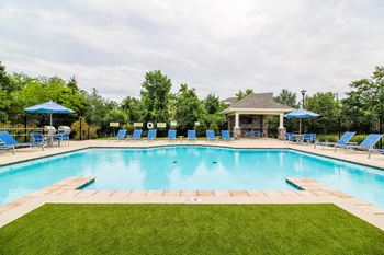 A pool with blue loungers and a gazebo at Aventura at Wentzville I & II Apartments, Wentzville, 63385