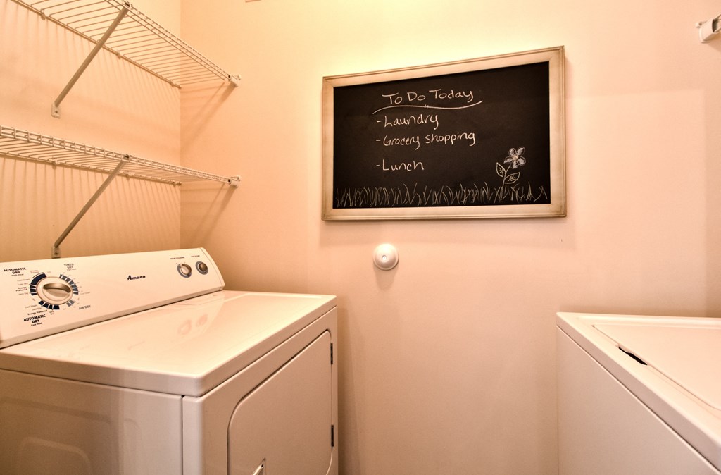 a washer and dryer in a laundry room with a chalkboard at Aventura at Richmond, St. Peters