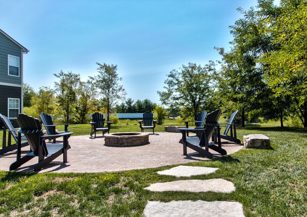 a patio with chairs and a fire pit in a park at Aventura at Richmond, St. Peters, Missouri