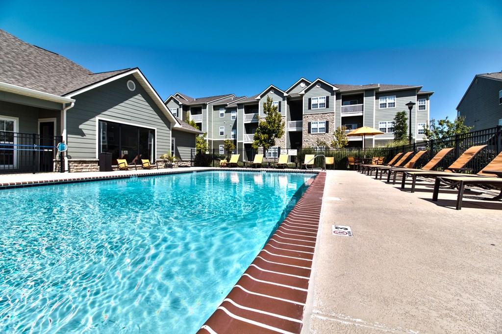 resort style pool area with lounge chairs at  Aventura at Richmond, Missouri