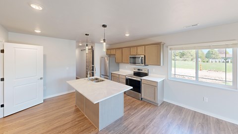 A kitchen with a white island and wooden cabinets.