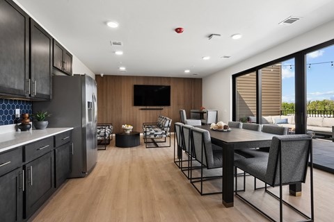 A modern kitchen with a dining table and chairs.