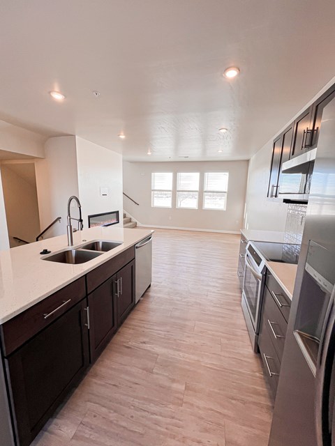 A kitchen with dark wood cabinets and stainless steel appliances.
