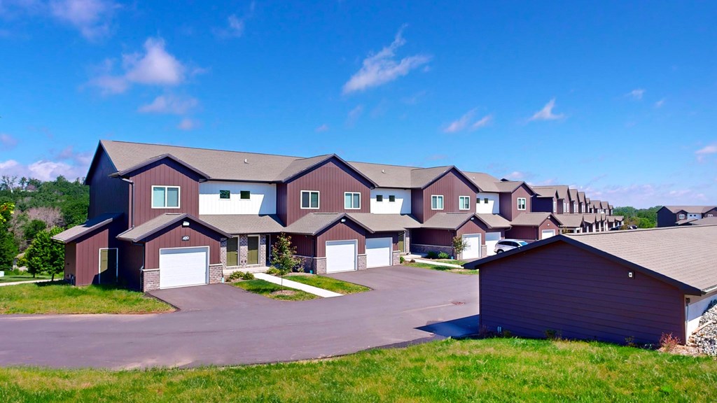 A large, modern house with a driveway and garage.