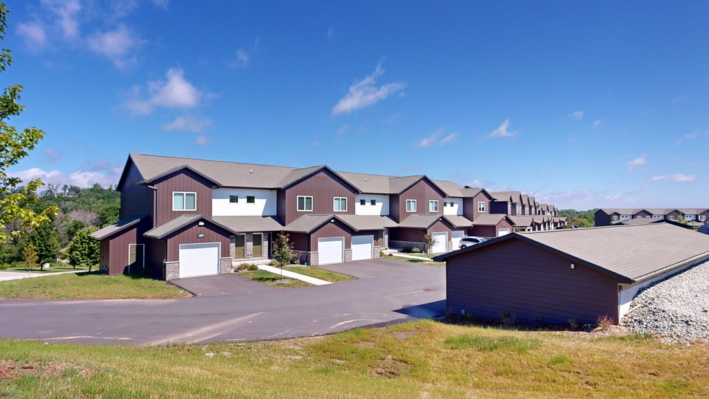 A row of houses with a clear blue sky above them.