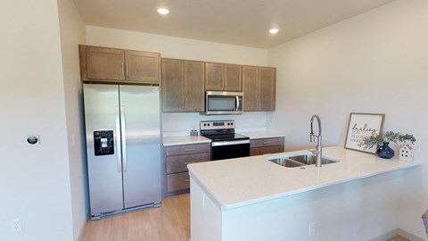 a kitchen with stainless steel appliances and a white counter top