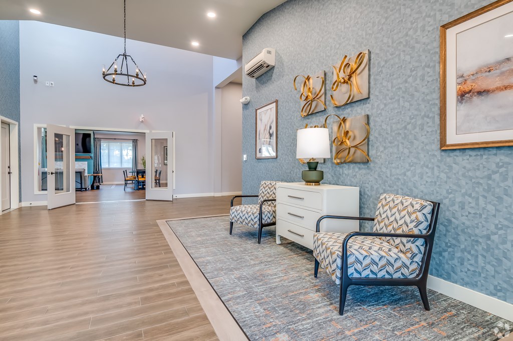 A living room with a blue wall and a chair.