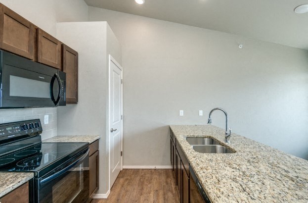 Kitchen with Granite Countertops and Black Appliances