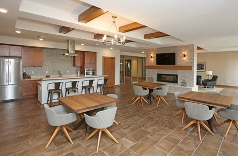 a dining room and kitchen with a table and chairs