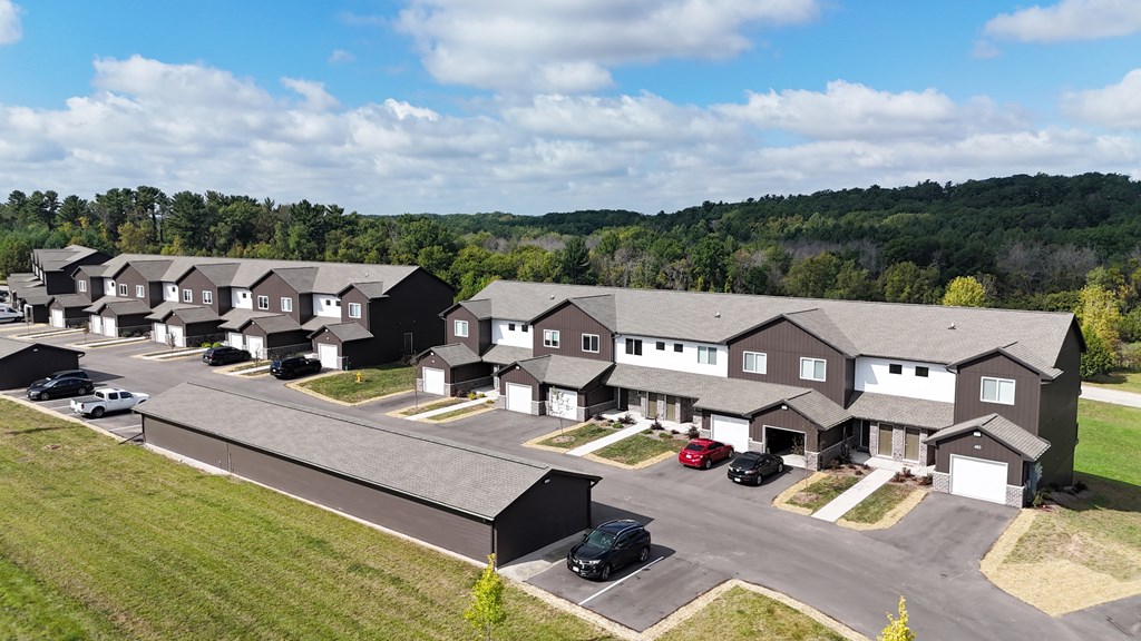 a aerial view of a group of houses and a parking lot