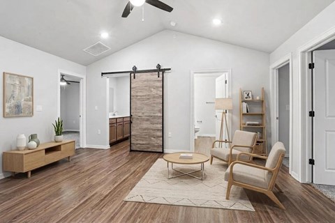 A living room with a sliding door and a rug on the floor.