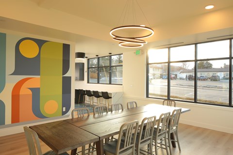 A conference room with a long table and chairs.