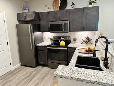 a kitchen with stainless steel appliances and granite counter tops