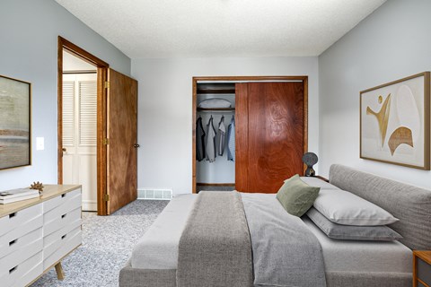 a bedroom with a bed and a dresser