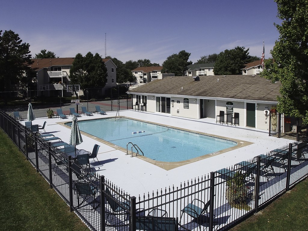 A black fence surrounds a small pool.