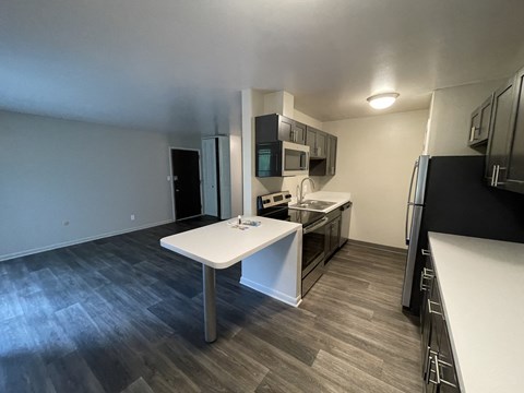 a kitchen with stainless steel appliances and a white table