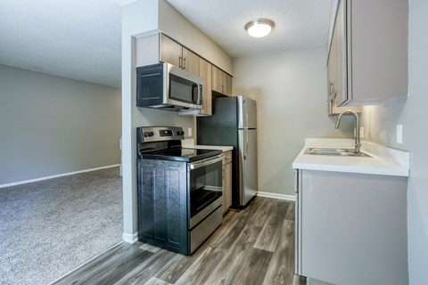a kitchen with stainless steel appliances and a white counter top
