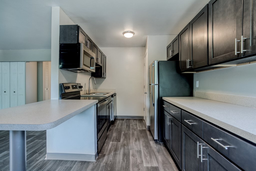 a kitchen with brown cabinets and white countertops
