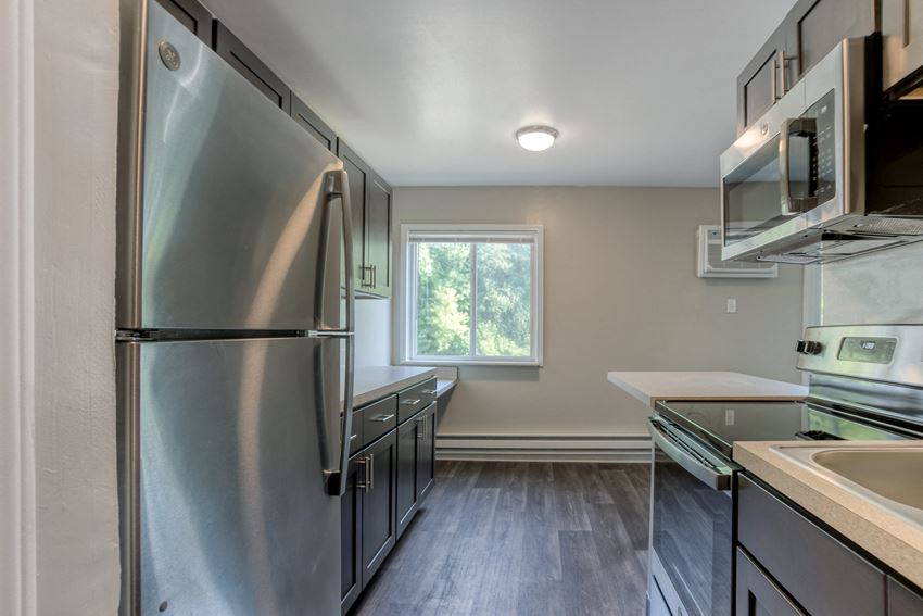 Bright Kitchen a kitchen with stainless steel appliances and brown cabinets - Photo Gallery