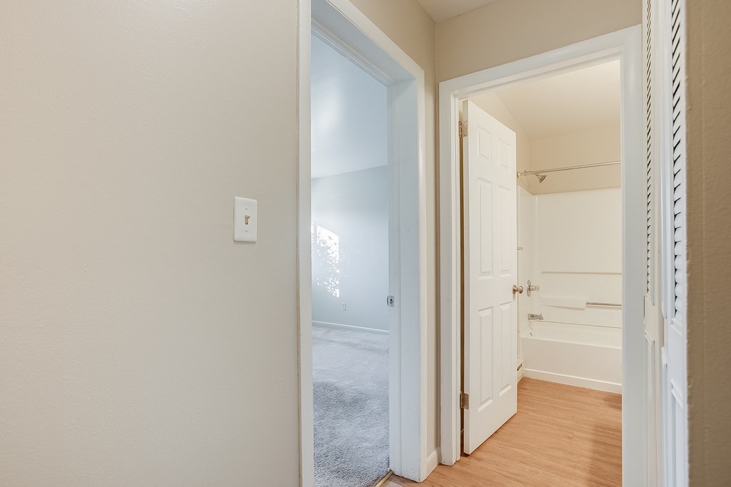 Hallway a bedroom with a closet and an open door