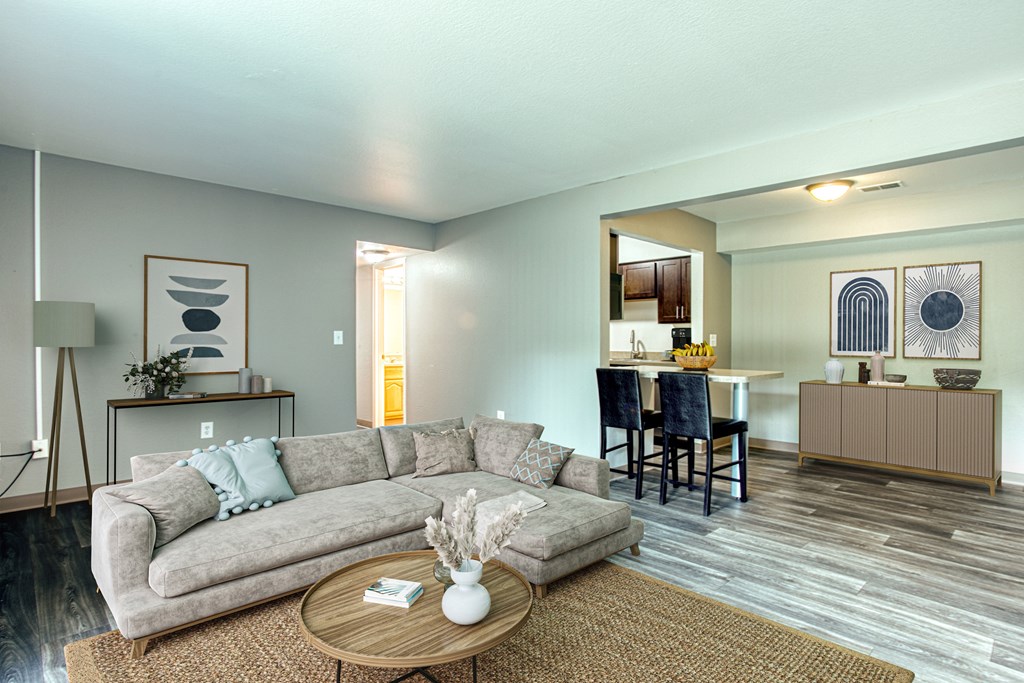 A living room with a grey couch and a coffee table.