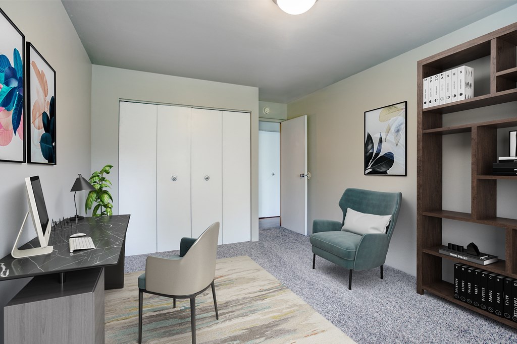 A room with a desk, chair, and shelves.