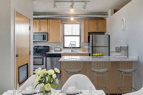 a kitchen with a table and chairs and a refrigerator