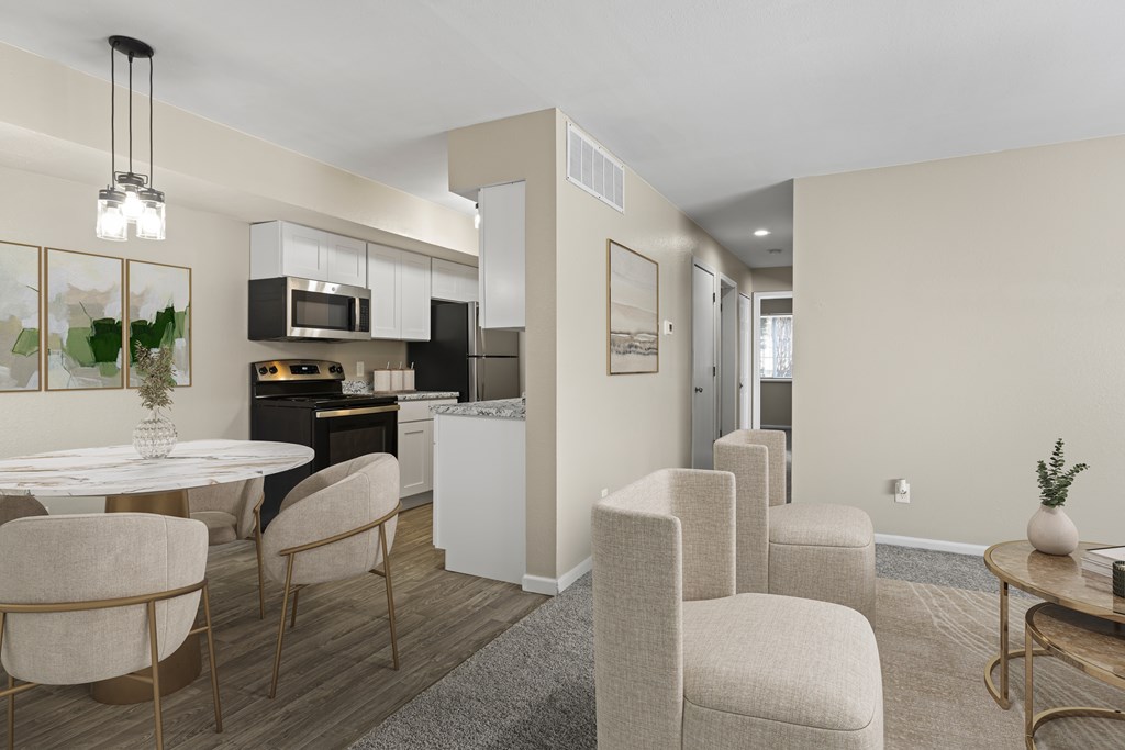 A modern kitchen with a dining table and chairs.