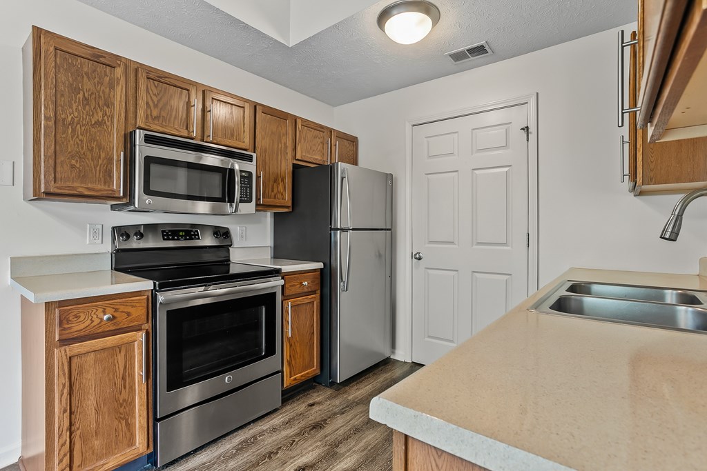 a kitchen with stainless steel appliances and wooden cabinets