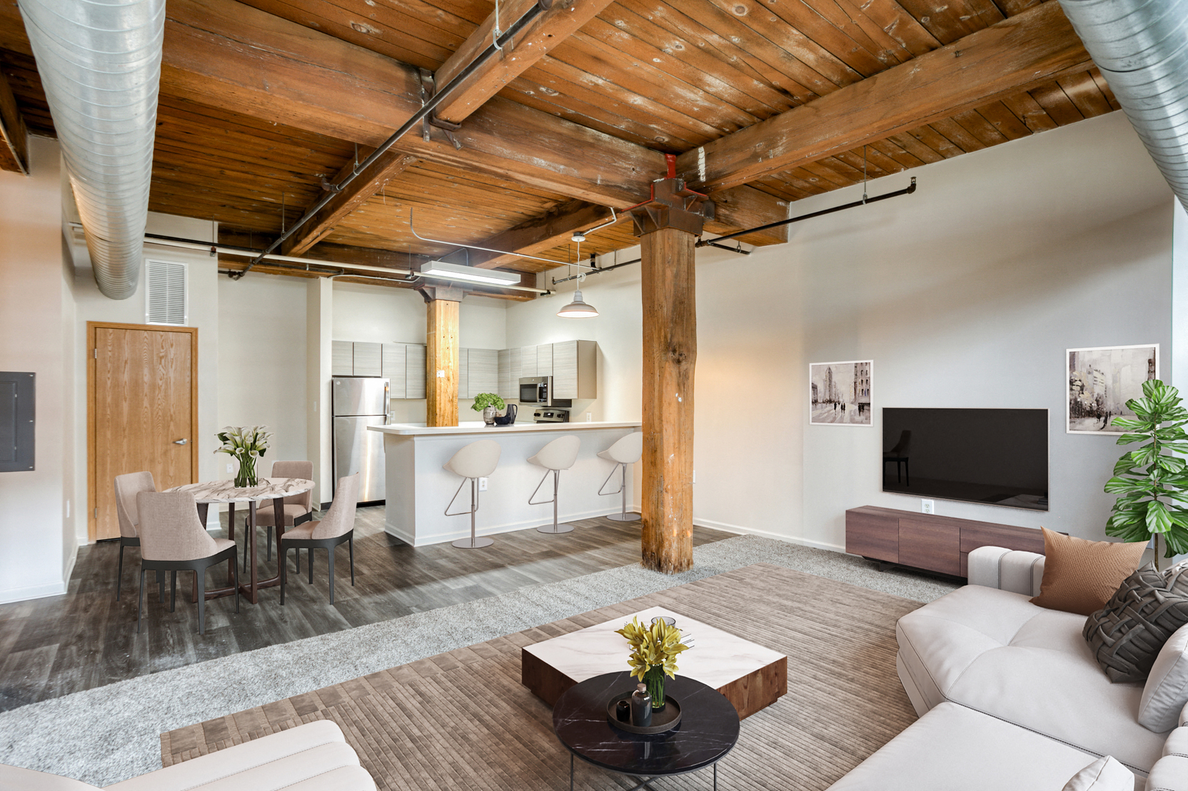 A living room with a white couch and a wooden ceiling.