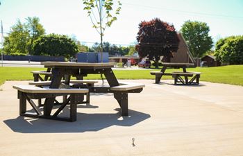 A picnic table is in the middle of a concrete area.