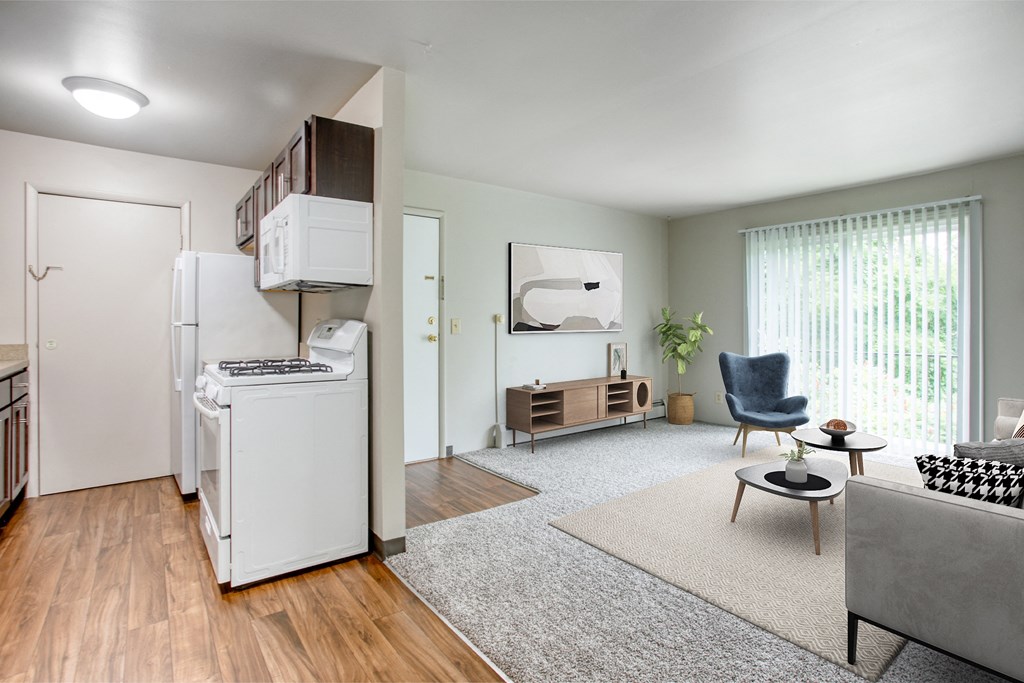 Java style kitchen with dark brown cabinetry and white appliances + gray living room
