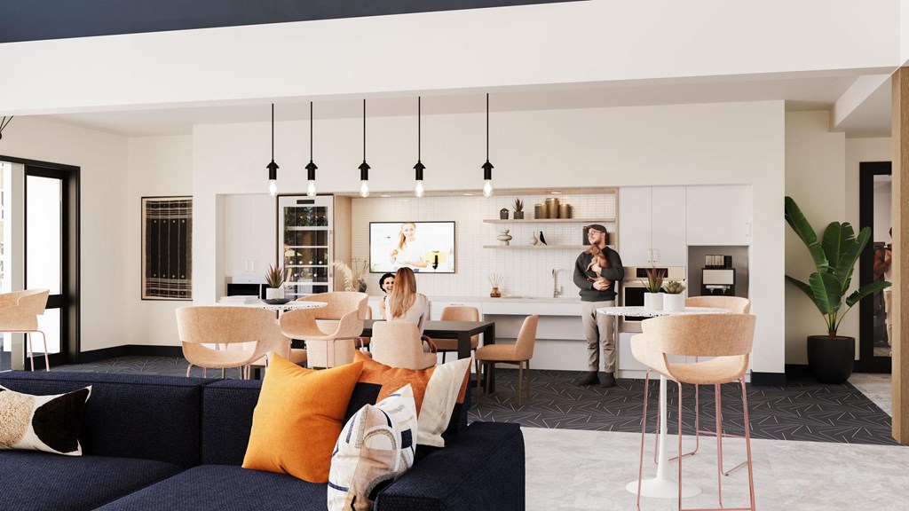 two women are sitting in a living room with a kitchen and dining room