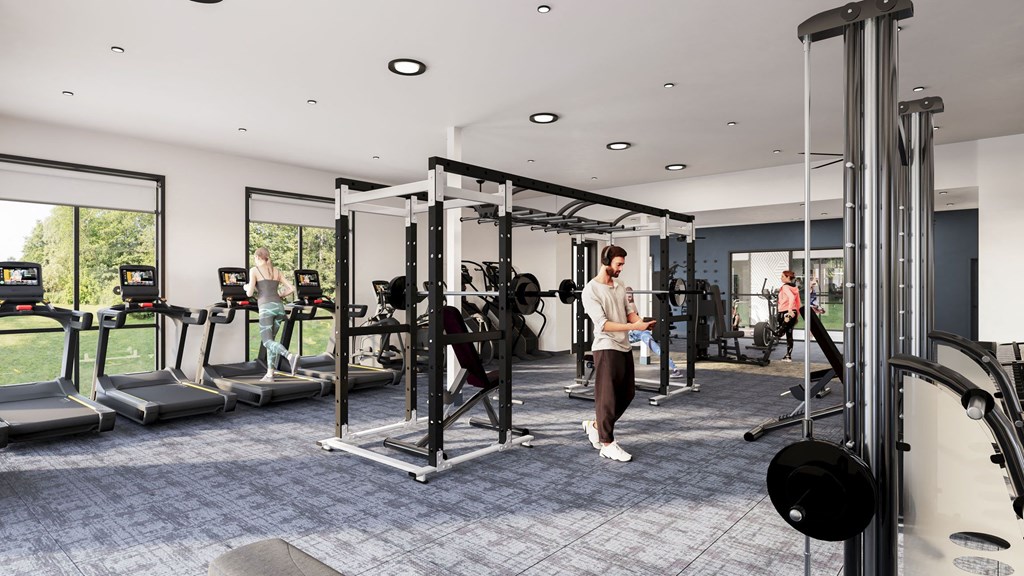 a man is standing in a gym with weights and other gym equipment